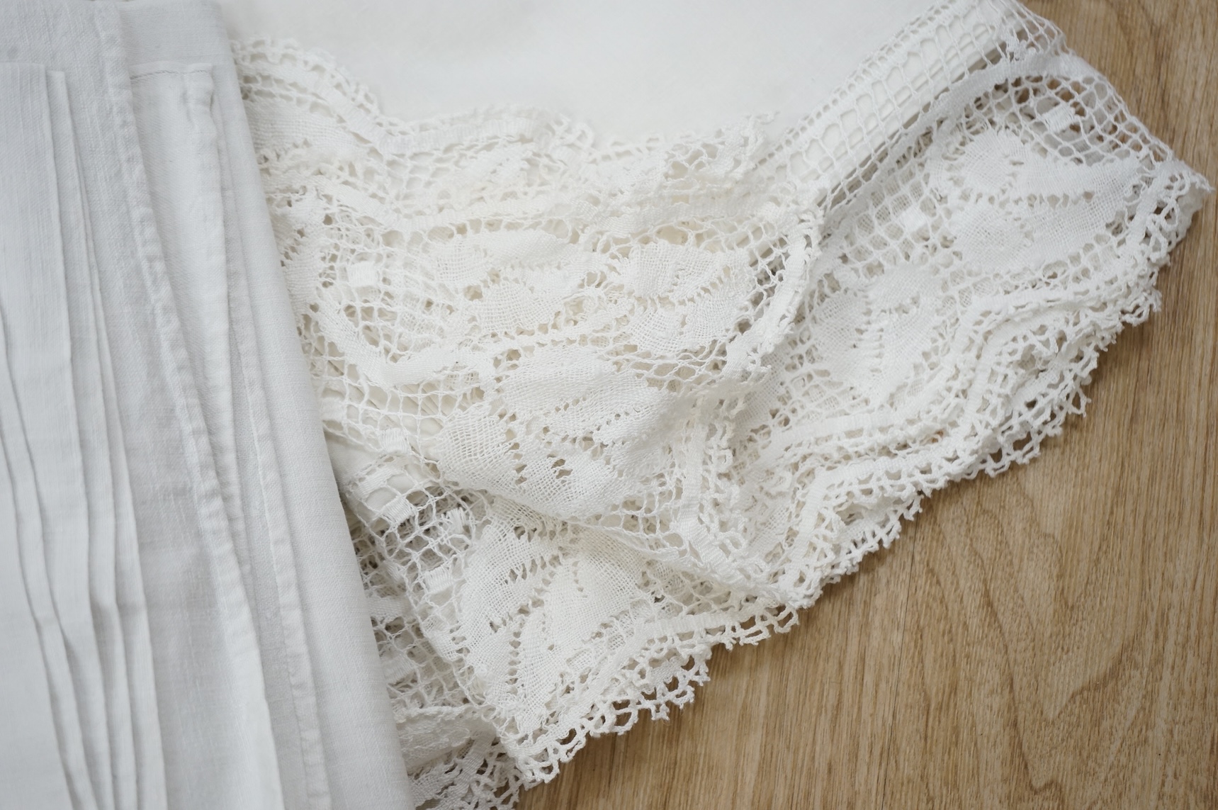A French provincial linen sheet with lace edge and insertions plus a pair of similar sheets with drawn thread and monograms